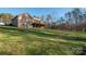 House back view, showcasing a large deck and wooded lot at 1350 Kensington Cir, Newton, NC 28658