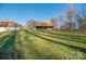Brick house with a deck, situated on a large lot with trees at 1350 Kensington Cir, Newton, NC 28658