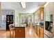 Eat-in kitchen with bay window, island, and hardwood floors at 13521 Toka Ct, Huntersville, NC 28078