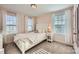 Bright bedroom with a white bed frame and soft pink walls at 137 Yellow Birch Loop, Mooresville, NC 28117