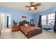 Blue bedroom with ceiling fan, carpet, and ensuite bathroom access at 141 Lilac Mist Loop # 109, Mooresville, NC 28115