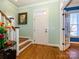 Bright entryway with hardwood floors, white door, and staircase at 141 Lilac Mist Loop # 109, Mooresville, NC 28115