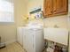 Laundry room with washer, dryer, sink, and storage cabinets at 141 Lilac Mist Loop # 109, Mooresville, NC 28115