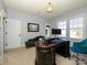 Home office with a stylish desk, comfortable seating, and natural light at 141 Lilac Mist Loop # 109, Mooresville, NC 28115