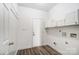 Bright laundry room with built-in cabinets and vinyl flooring at 3028 Semmes Ln, Indian Trail, NC 28079