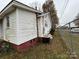 Side view of the house with white siding and a red foundation at 3042 N Oxford St, Claremont, NC 28610