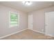 Vacant bedroom featuring neutral walls, carpeting, and a window with natural light at 3201 Oscar Dr, Matthews, NC 28105