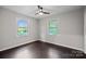 Bright bedroom featuring ample natural light from large windows and dark flooring at 401 Stokes Ave, Clover, SC 29710