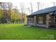 Exterior view of the home's back, showcasing a covered porch, brick construction, and a grassy lawn at 4531 Deer Run Rd, Rock Hill, SC 29732