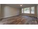 Living room with wood-style flooring, ceiling fan, and large windows at 4531 Deer Run Rd, Rock Hill, SC 29732