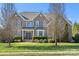 Brick two-story house with a landscaped lawn and a large driveway at 5225 Firebrick Sw Ln, Concord, NC 28025