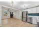 Modern kitchen featuring white cabinetry, stainless steel appliances, and teal tile backsplash at 725 Shannon Bradley Rd, Gastonia, NC 28052