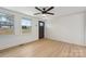 Bright living room with a ceiling fan and several windows at 725 Shannon Bradley Rd, Gastonia, NC 28052