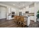 Bright, spacious kitchen with white cabinets, an island with seating, and sleek stainless steel appliances at 8624 Miles Gap Rd, Indian Land, SC 29707