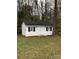 White detached outbuilding/shed with black shutters and double doors at 9608 Sunway Dr # 4, Mint Hill, NC 28227