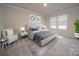 Main bedroom with plush bed, carpet flooring, and a seating area at 102 Alden Ct, Shelby, NC 28152