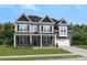 Exterior of a two-story house with a front porch, gray siding, and landscaping at 128 Balboa St # 25, Matthews, NC 28104