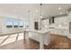Modern kitchen with white cabinets, stainless steel appliances, and a large island at 128 Balboa St # 25, Matthews, NC 28104