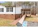 Home's side view showcasing a covered deck and accessible ramp at 1370 Poole Rd, Salisbury, NC 28146