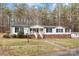 Ranch-style home with white siding, brick foundation, and mature trees at 1370 Poole Rd, Salisbury, NC 28146