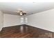 Large bedroom with dark hardwood floors and a ceiling fan at 14331 Lyon Hill Ln, Huntersville, NC 28078