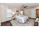 Bright bedroom with wood floors, ceiling fan, and ample natural light at 14331 Lyon Hill Ln, Huntersville, NC 28078