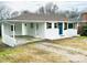 White single-story home with carport, blue door, and some landscaping at 1507 W Horah St, Salisbury, NC 28144