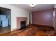 Living room with hardwood floors and a brick fireplace at 306 E Herman St, Newton, NC 28658