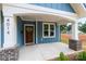 Covered front porch with brick accents and a wooden front door at 4014 Avalon Ave, Charlotte, NC 28208