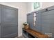 Mudroom with built-in bench, hooks, and gray shiplap walls at 4014 Avalon Ave, Charlotte, NC 28208