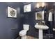 Powder room with dark blue shiplap walls, pedestal sink, and gold accents at 4014 Avalon Ave, Charlotte, NC 28208