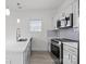 Sleek and modern kitchen design with white cabinetry, stainless steel appliances, and large sink at 402 N Battleground Ave, Kings Mountain, NC 28086