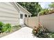 Exterior view of the house with a side entrance, fenced area, and landscaping at 6737 Harrison Rd, Charlotte, NC 28270