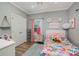 Vibrant bedroom with playful pink accents and whimsical wall decorations at 8007 Stevens Mill Rd, Matthews, NC 28104