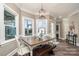 Bright breakfast nook with window views and wooden table at 8007 Stevens Mill Rd, Matthews, NC 28104