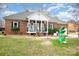 Brick ranch house with a covered porch and yard at 8007 Stevens Mill Rd, Matthews, NC 28104