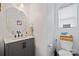 Bathroom with gray vanity, white countertop, and decorative mirror at 910 Mibbs Pl, Statesville, NC 28625