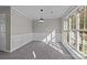 Bright dining room with large window, wainscoting, and gray carpet at 183 Bellelaine Dr, Mooresville, NC 28115