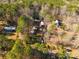 Aerial showing home, multiple outbuildings, and large lot with mature trees at 5040 Spicewood Dr, York, SC 29745