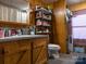 Clean bathroom with vanity, toilet, shower, and shelving for storage at 5040 Spicewood Dr, York, SC 29745