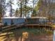 Mobile home with large deck and ramp access, surrounded by trees at 5040 Spicewood Dr, York, SC 29745