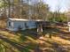 Mobile home with deck and ramp access, nestled in a wooded area at 5040 Spicewood Dr, York, SC 29745