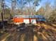 Red metal storage building with double doors and covered porch at 5040 Spicewood Dr, York, SC 29745