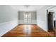 Bright dining room with hardwood floors, wainscoting, and elegant light fixture at 520 Beacon Knoll Ln, Fort Mill, SC 29708