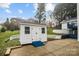 White storage shed in backyard with concrete patio and retaining wall at 5680 Gold Creek Bay None, Hickory, NC 28601