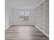 Bright home office with built-in shelving and wood-look flooring at 5680 Gold Creek Bay None, Hickory, NC 28601