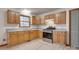 Bright kitchen with light wood cabinets, stainless steel appliances, and laminate flooring at 7907 Royal Ct, Waxhaw, NC 28173