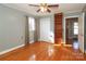 Bedroom with hardwood floors, built-in shelves, and ceiling fan at 808 Mark St, Belmont, NC 28012