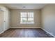 Spacious bedroom with wood-look floors and window at 10429 Gold Pan Rd, Charlotte, NC 28215