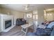 Open living room with a fireplace, hardwood floors, and views into the kitchen at 10429 Gold Pan Rd, Charlotte, NC 28215